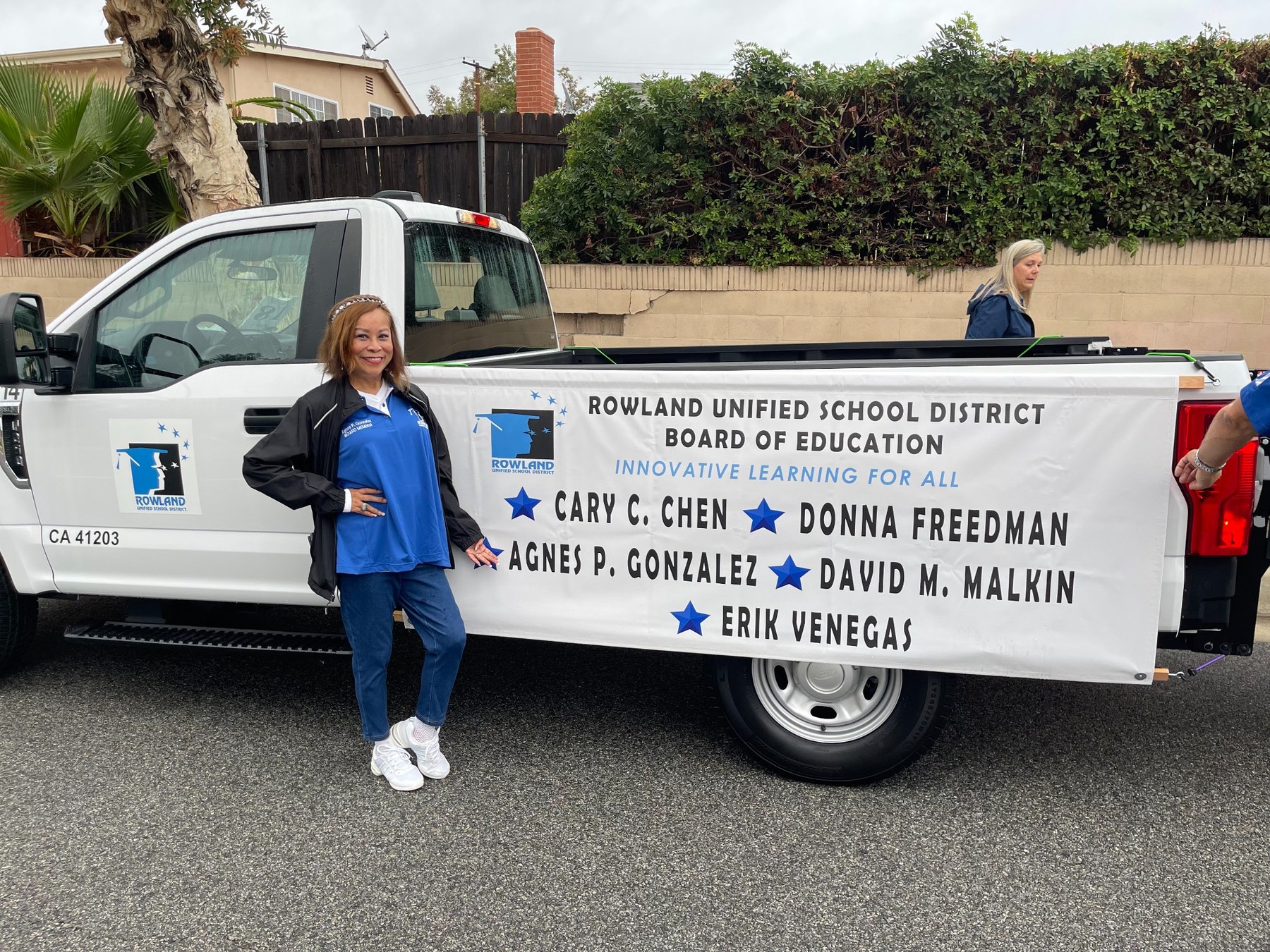 Community service beside a Rowland Unified Board of Education vehicle.