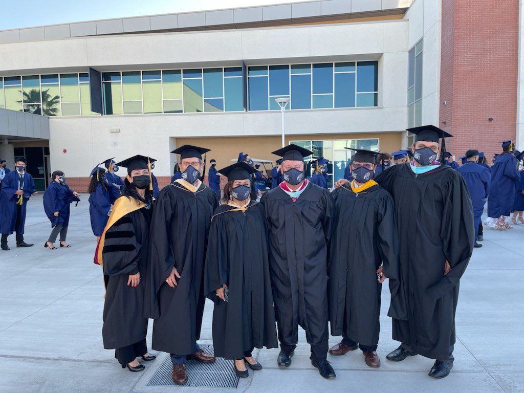 Educators and school leaders gathered at a graduation event.