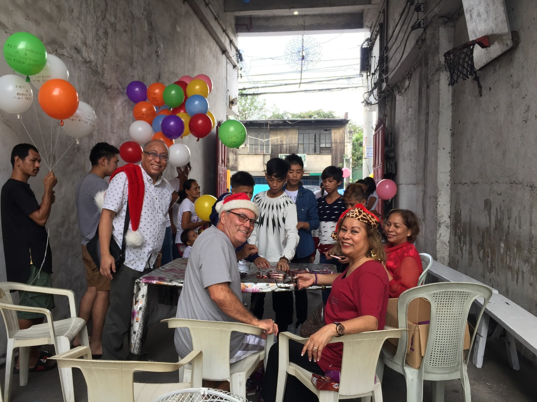 Agnes Gonzalez with volunteers and community members during a holiday giving event.